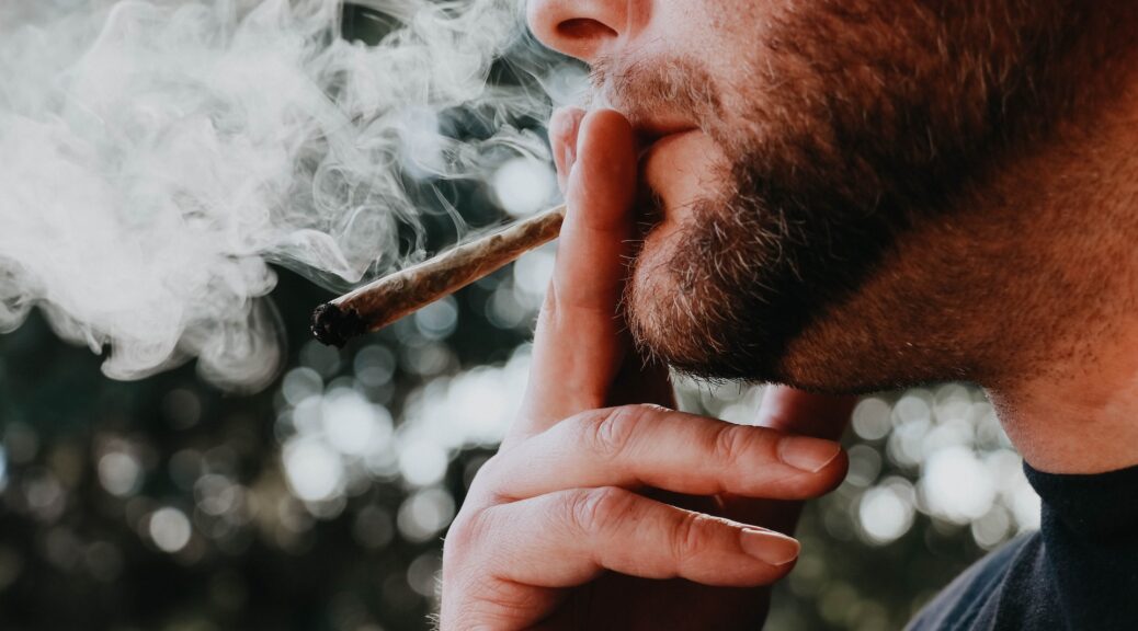 A man smoking a joint