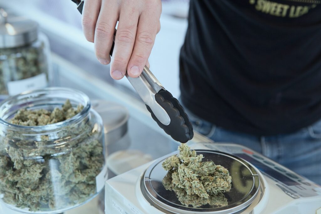 A budtender weighing out nugs