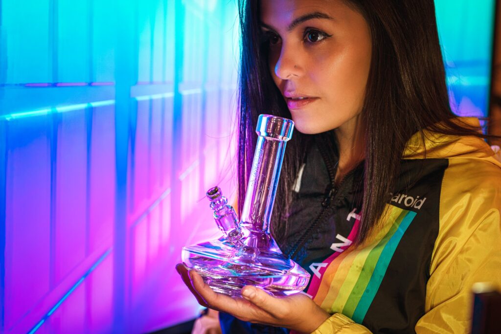 A woman holding a bong