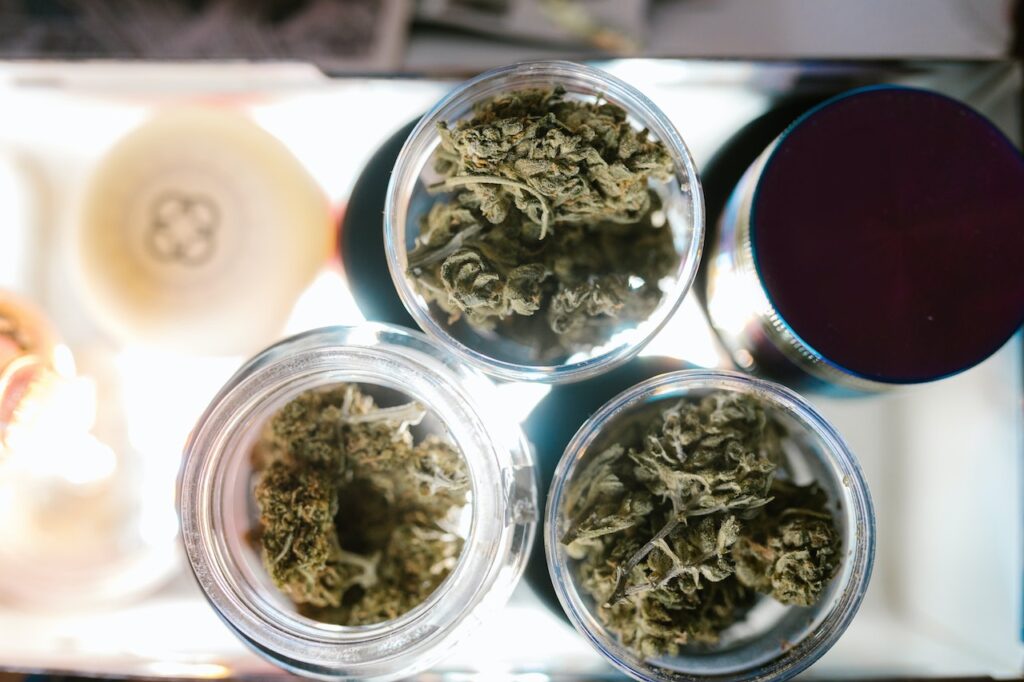 Multiple types of weed in clear jars viewed from above