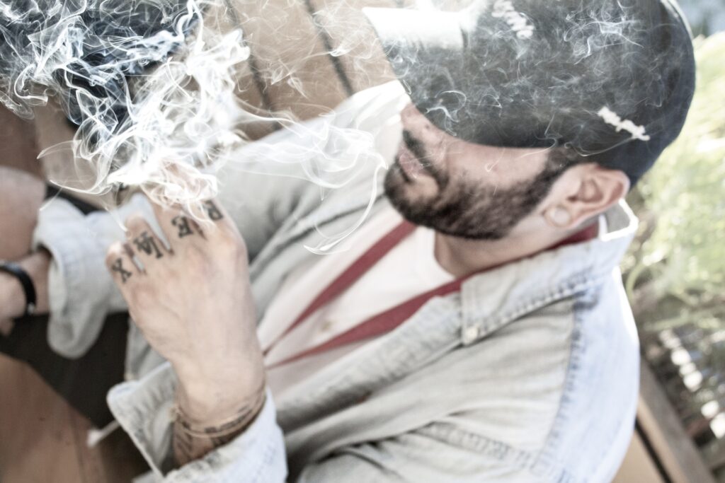 A man smoking cannabis and relaxing