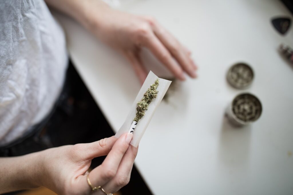 A woman rolling a joint